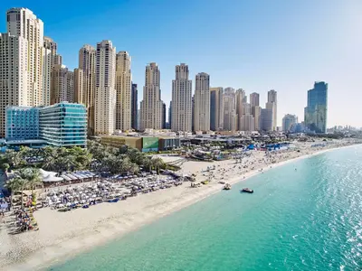 an aerial view of a beach with people and buildings at Hilton Dubai Jumeirah in Dubai