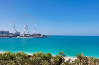 a view of the beach and the ferris wheel at Hilton Dubai Jumeirah in Dubai