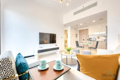 a living room with a couch and a table at Spotless 1BR at UNA Town Square Dubailand by Deluxe Holiday Homes in Dubai