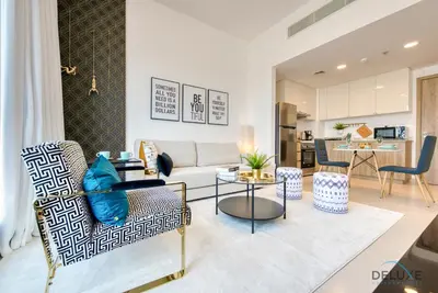 a living room with a couch and a table at Charismatic 1BR at UNA Town Square Dubailand by Deluxe Holiday Homes in Dubai