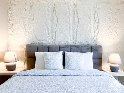 a bedroom with a bed with pillows and two lamps at Dubai Mall 1Bedroom Balcony in Dubai