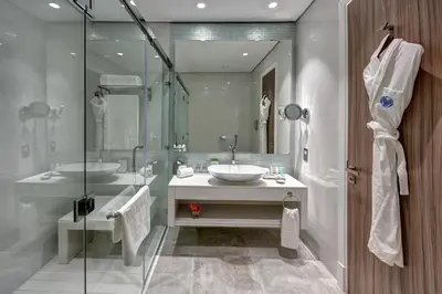 a bathroom with two sinks and a shower at Arjaan by Rotana - Dubai Media City in Dubai
