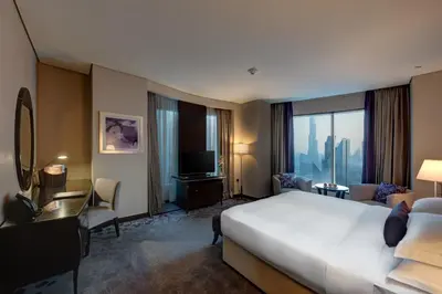 a hotel room with a large bed and a television at Rose Rayhaan by Rotana - Dubai in Dubai