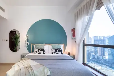a bedroom with a large bed and a large window at The Smart Concierge - Bahar 6 in Dubai