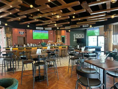 a restaurant with tables and chairs and a bar at Millennium Lakeview Hotel in Dubai