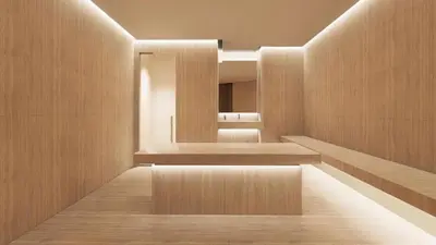 a bathroom with wooden walls and a large mirror at Millennium Lakeview Hotel in Dubai