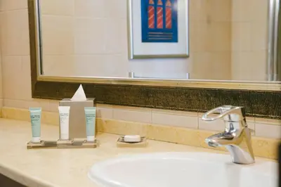 a bathroom sink with two toothbrushes and a mirror at Millennium Lakeview Residences in Dubai