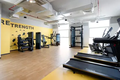 a gym with treadmills and elliptical machines at Ecos Dubai Hotel at Al Furjan in Dubai