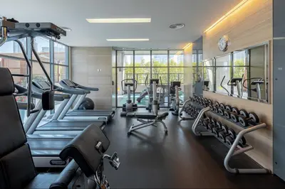 a gym with several treadmills and cardio machines at Radisson Blu Residence, Dubai Marina in Dubai