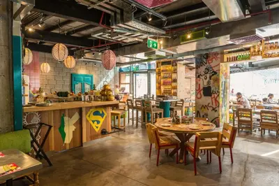 a restaurant with tables and chairs and a bar at Radisson Blu Residence, Dubai Marina in Dubai