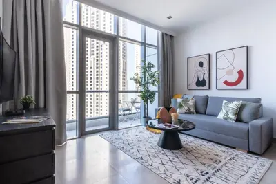 a living room with a couch and a table at The Smart Concierge - Bay Central in Dubai