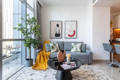 a living room with a couch and a table at The Smart Concierge - Bay Central in Dubai
