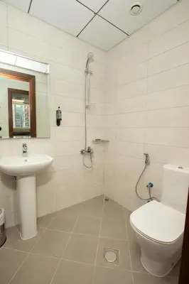 a bathroom with a toilet and a sink at Grand Stay Holiday Homes Rental in Dubai