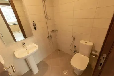 a small bathroom with a toilet and a sink at Grand Stay Holiday Homes Rental in Dubai