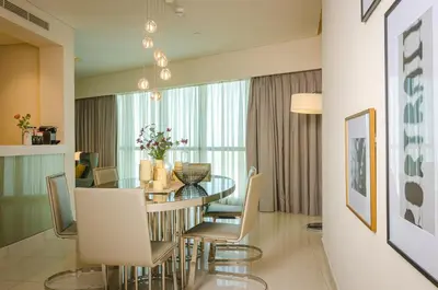 a dining room with a table and chairs at Royal Club By RVHR, Paramount Tower B, Business Bay in Dubai