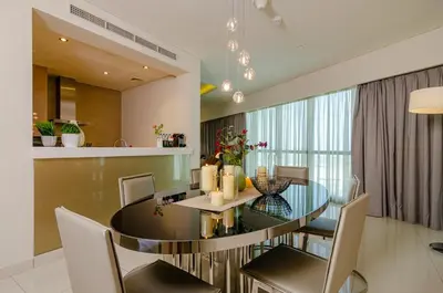 a dining room with a glass table and chairs at Royal Club By RVHR, Paramount Tower B, Business Bay in Dubai