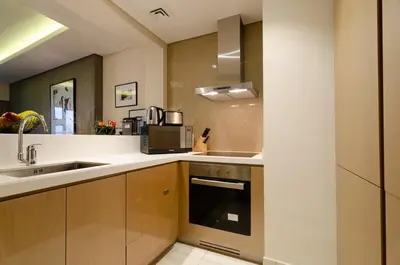 a kitchen with a sink and a microwave at Royal Club By RVHR, Paramount Tower B, Business Bay in Dubai