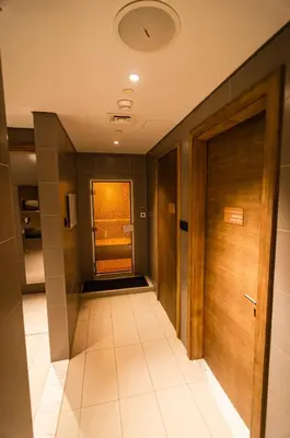 a hallway with a door and a tile floor at Royal Club By RVHR, Paramount Tower B, Business Bay in Dubai