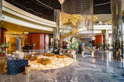 a lobby of a hotel with a grand piano at Royal Club By RVHR, Paramount Tower B, Business Bay in Dubai