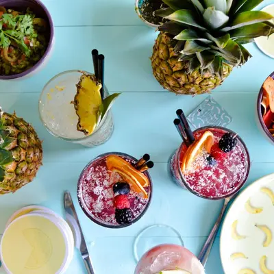 a table topped with glasses of fruit and cocktails at Holiday Inn Express Dubai Safa Park by IHG in Dubai