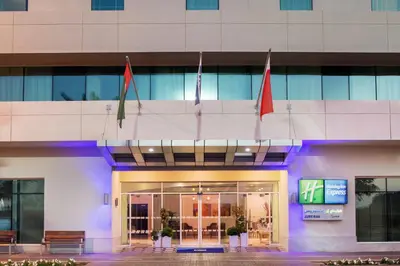 a building with flags in front of it at Holiday Inn Express Dubai, Jumeirah by IHG in Dubai