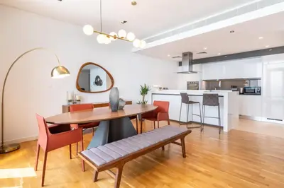 a dining room and kitchen with a table and chairs at GuestReady - The Best Bluewaters View in Dubai