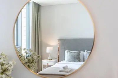 a bedroom with a bed and a mirror at GuestReady - The Best Bluewaters View in Dubai