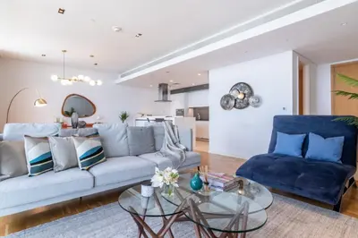 a living room with a couch and a glass table at GuestReady - The Best Bluewaters View in Dubai