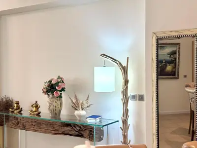 a living room with a table and a mirror at Luxury - Beachfront - Spacious Shoreline residences - 5 star private beach resort in Dubai