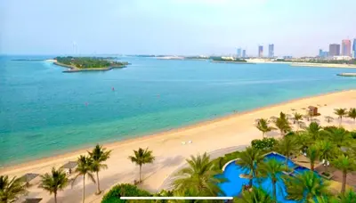 an aerial view of a beach with palm trees and the ocean at Luxury - Beachfront - Spacious Shoreline residences - 5 star private beach resort in Dubai