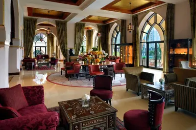 a living room with red furniture and a table at Palace Downtown in Dubai