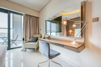 a room with a large mirror on the wall at Maison Privee - Cool Dubai Apt next Burj Khalifa & Design District in Dubai