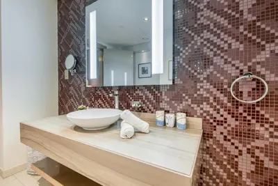 a bathroom with a sink and a mirror at Maison Privee - Cool Dubai Apt next Burj Khalifa & Design District in Dubai
