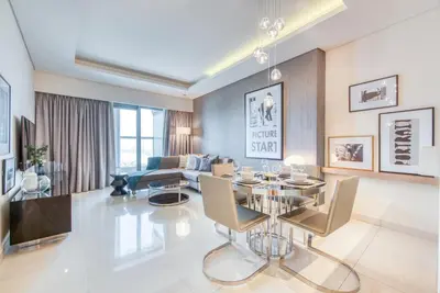 a living room with a table and a couch at Maison Privee - Cool Dubai Apt next Burj Khalifa & Design District in Dubai