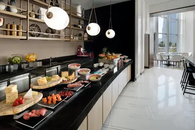 a kitchen with many plates of food on a counter at Address Downtown in Dubai
