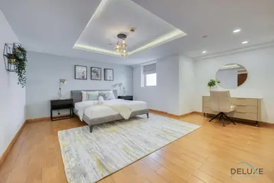 a bedroom with a bed and a desk and a chair at Outstanding 3BR at Sadaf 7 JBR by Deluxe Holiday Homes in Dubai