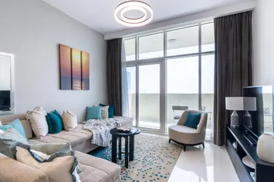 a living room with a couch and a tv at The Smart Concierge - Damac 108 in Dubai