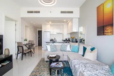 a living room with a couch and a table at The Smart Concierge - Damac 108 in Dubai
