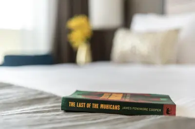 a book sitting on top of a bed at The Smart Concierge - Damac 108 in Dubai