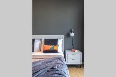 a bedroom with a bed and a night stand with a lamp at The Smart Concierge - Bahar 6 in Dubai