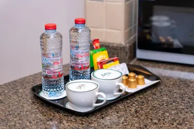 a tray with two water bottles and two cups on a counter at Belle Vue Building in Dubai