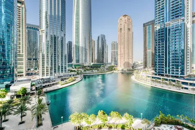 a river in the middle of a city with tall buildings at Calm Studio at Lake View Tower JLT by Deluxe Holiday Homes in Dubai