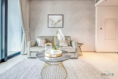 a living room with a couch and a table at Exquisite 1BR at The Address Residences in JBR by Deluxe Holiday Homes in Dubai