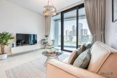 a living room with a couch and a large window at Exquisite 1BR at The Address Residences in JBR by Deluxe Holiday Homes in Dubai