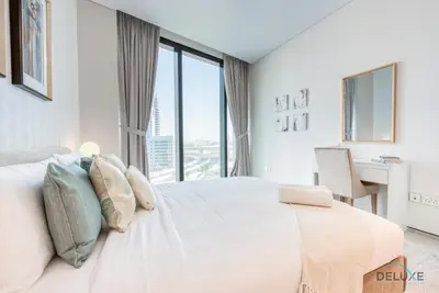 a white bedroom with a large bed with a window at Exquisite 1BR at The Address Residences in JBR by Deluxe Holiday Homes in Dubai