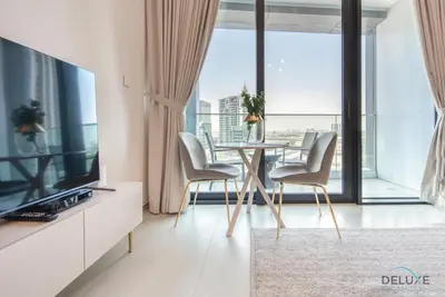 a dining room with a table and chairs and a large window at Classy 1BR at The Address Residences in JBR by Deluxe Holiday Homes in Dubai
