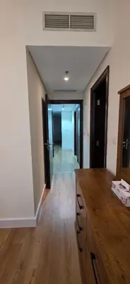 a kitchen with a wooden counter and a hallway at Cozy 2 BR apt Golf Tower Greens, stunning Golf views in Dubai
