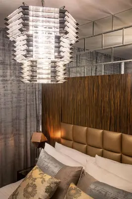 a bedroom with a bed and a large chandelier at Royal Club By RVHR, Bonnington Residential Tower - JLT in Dubai