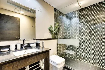 a bathroom with a sink and a toilet at Cayan Tower, Dubai Marina in Dubai