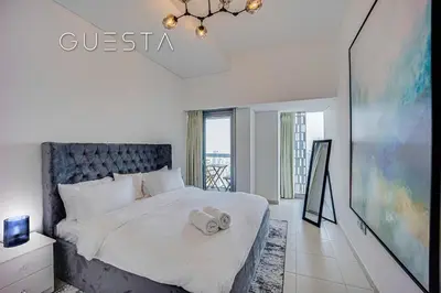 a bedroom with a bed and a large window at Cayan Tower, Dubai Marina in Dubai